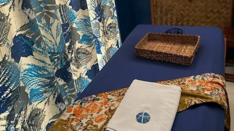 A massage room at Amacan Spa Tiniguiban, with an amakan wall and blue floral curtains